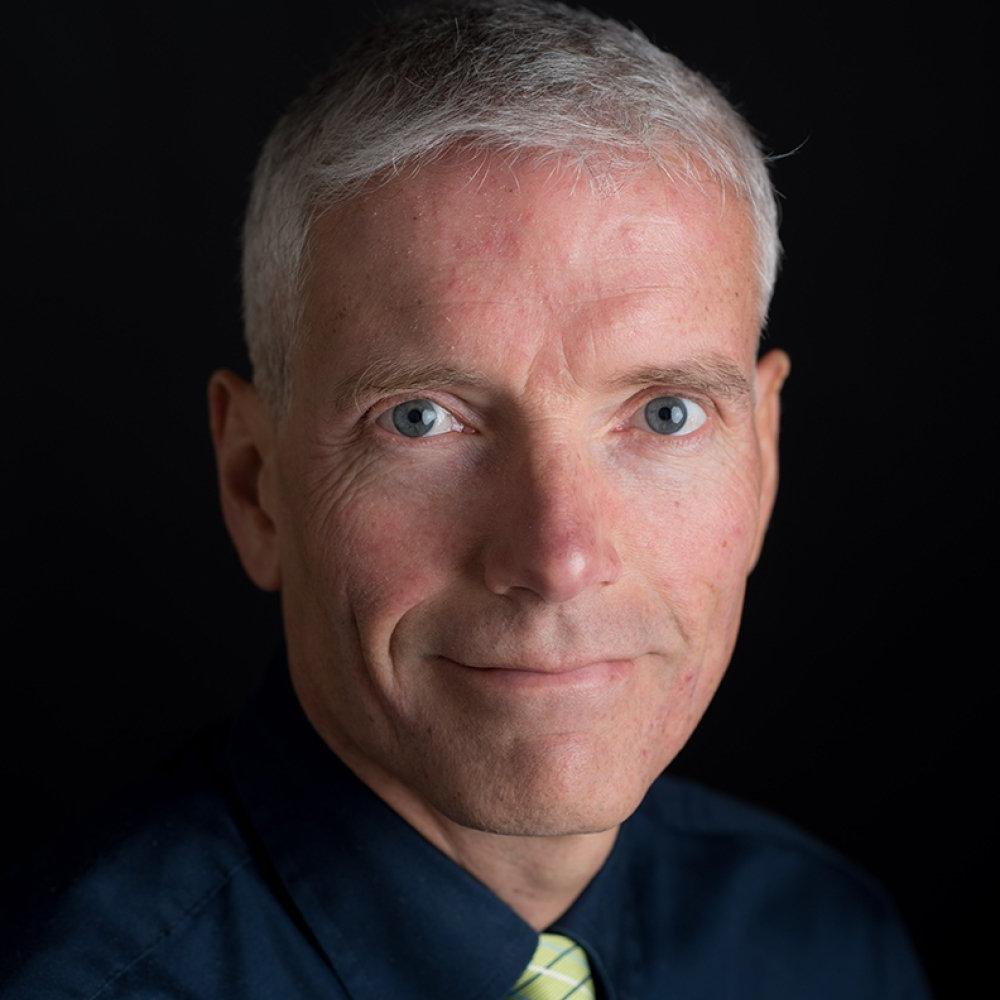 David Anderson - man wearing black dress shirt with green striped tie